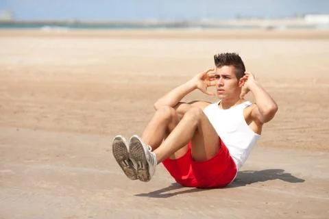 Young man making abs exercise  Stock Photos