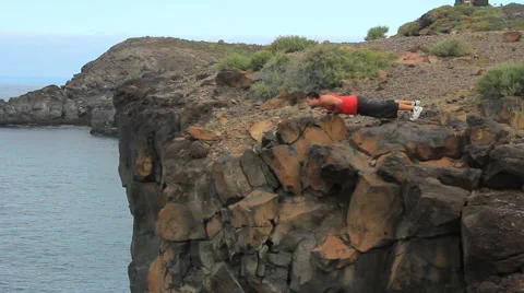 Young man making exercises outdoor. Sunny day. Location Tenerife. Stock Footage 65446822