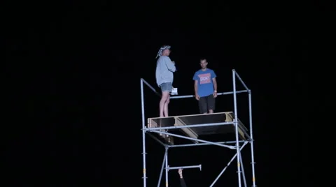 Young Man Making Flips From a Height to the Big Airbag at Night Stock Footage 59894165