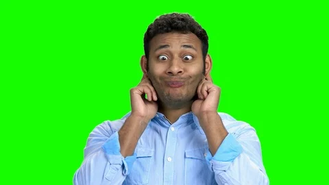 Young man making funny face on green screen. 库存影片 106427803