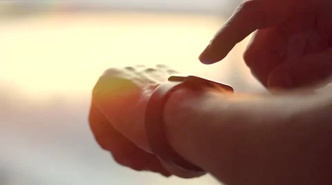 Young man making gestures on a wearable smartwatch Stock Footage 67359679