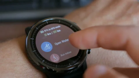 Young man making gestures on a wearable smart watch computer device, smartwat Stock Footage 96005629