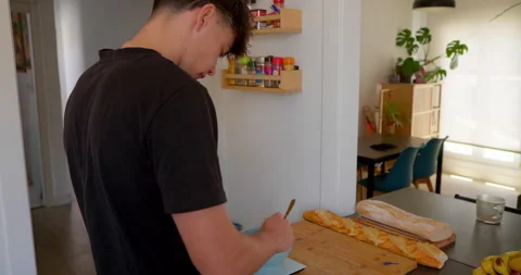 A young man is making himself a healthy breakfast Stock Footage 336141808