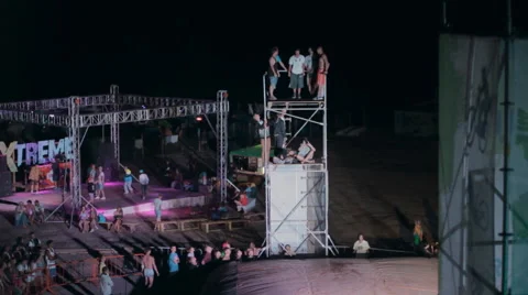 Young Man Making a Jump From a Springboard To to the Big airbag night Stock Footage 59896146
