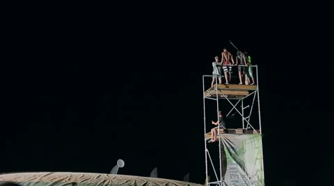 Young Man Making a Jump From a Springboard to to the Big Airbag Night. Slow Stock Footage 60681512