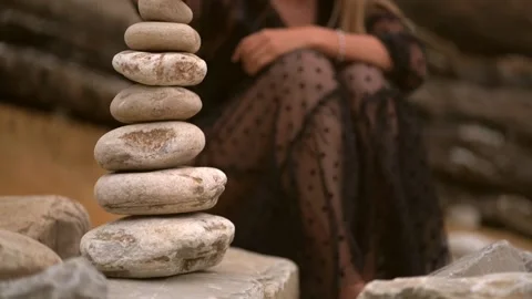Young man making a mountain of stones. Stock Footage 133696674