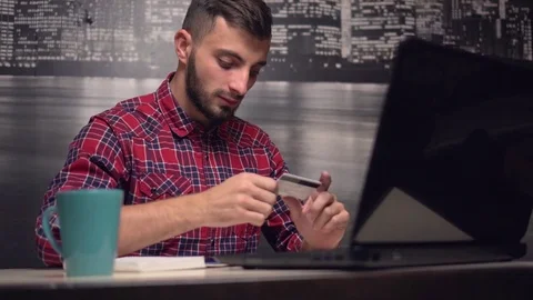 Young Man Making Online Payment with Credit Card Stock Footage 70103457