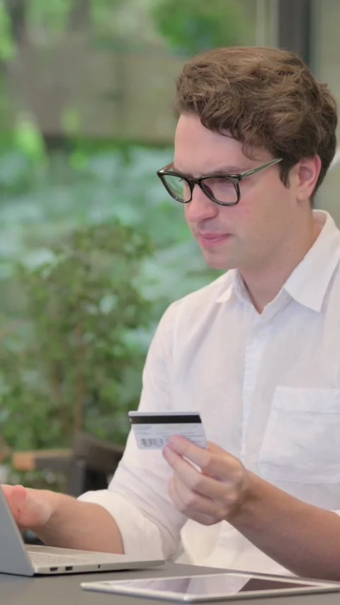 Young Man making Online Payment Failure on Laptop in Modern Office, Vertical Stock Footage 340032148
