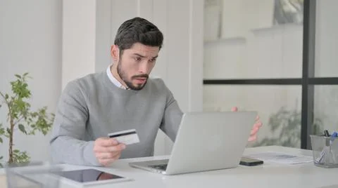 Young Man making Online Payment Failure on Laptop in Office Stock Photos
