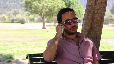Young Man Making A Phone Call In The Park Stock Footage 75806486