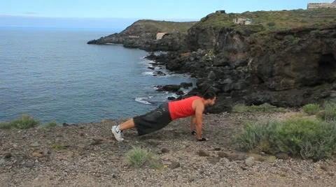 Young man making push-ups outdoors. Sunny day, dolly shot. Video stock 65446805