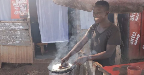 Young man is making a rolex, a popular street food in Uganda, combining an egg Stock Footage 109490601