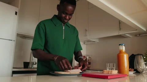 Young Man Making a Sandwich in Kitchen Stock Footage 305954455