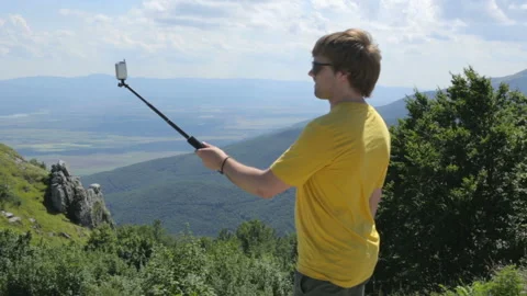 Young man making selfie on mountain Stock Footage 96164870