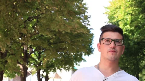 Young man making a selfie in a park Video stock 65339187