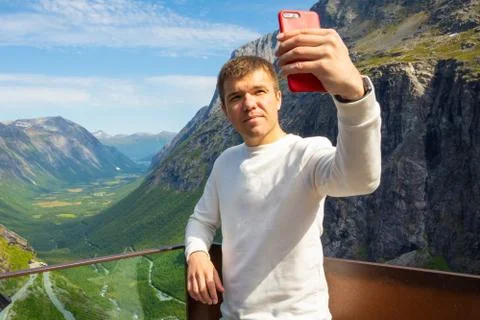 Young man making selfie on Trollstigen serpentine road, Norway Stock Photos