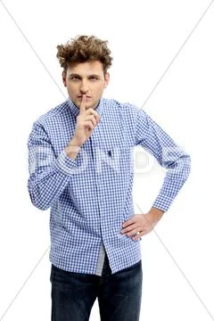 Young man making silence gesture Stock Photos