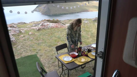 Young man making table At Camping outdoor with lake and mountains background Stock Footage 201831847