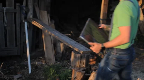 Young man making video call at the sawmill with laptop computer in his hands Stock Footage 64776314