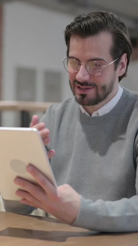 Young Man making Video Call on Tablet in Office, Vertical Video Stock Footage 339580955