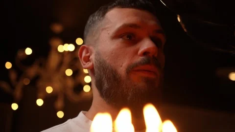 Young man making a wish and blowing candles on birthday cake 스톡 동영상 255047259