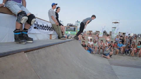 Young Man man Riding on The Rollers During a roller-skating competitions Stock Footage 59898593