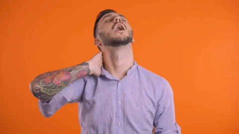 Young man man suffering from neck pain, touching his neck and head, giving it a Stock Footage 138519717