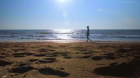 A young man, a man walking on the waves on the seashore. The general plan. Stock Footage 162191604