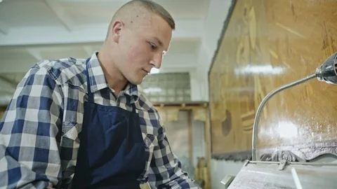 A young man manually lathing a piece of timber Video stock 100609982