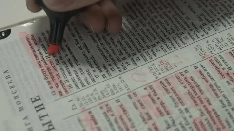 A young man marker highlights interesting Bible verses Stock Footage 130600642