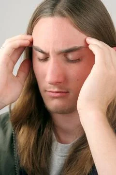Young Man Massaging Temples Stock Photos