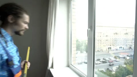 A young man measure the window Stock Footage 65287893