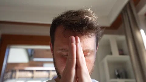Young man meditating with hands in prayer pose at home 스톡 동영상 328228360