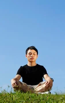 Young man meditating Stock Photos