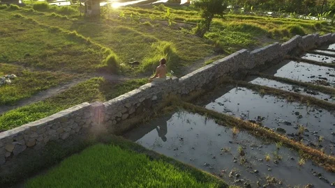 Young Man Meditating While Bathing in Sunlight With Lens Flare Stock Footage 119860748