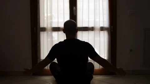 Young man meditation in front of the window. Health and relaxation. Yoga concept Stock Footage 127255604