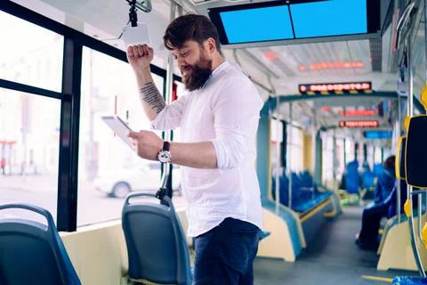 Young man messaging in train Stock Photos