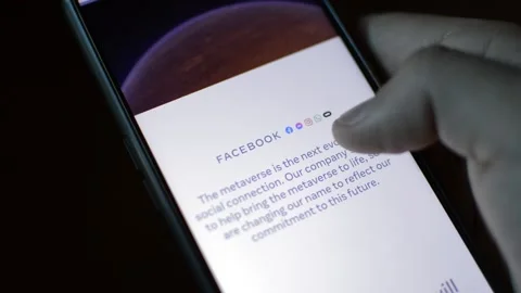 Young man with meta by facebook logo on his phone. cyberspace network Stock Footage 175685494