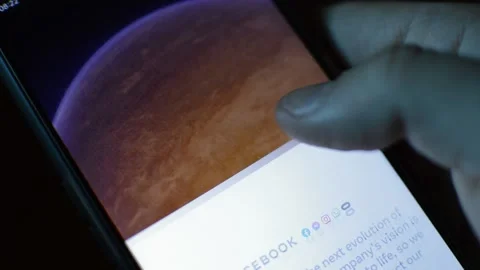 Young man with meta by facebook logo on his phone. cyberspace network Stock Footage 175686648