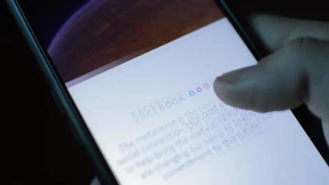 Young man with meta by facebook logo on his phone. cyberspace network Stock Footage 175687010