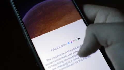 Young man with meta by facebook logo on his phone. cyberspace network Stock Footage 175687553