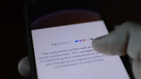 Young man with meta by facebook logo on his phone. cyberspace network Stock Footage 175688382