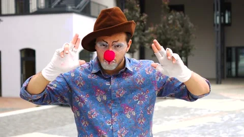 Young man mime actor did the hands in the shape of a gun and made a shot right 스톡 동영상 137427129
