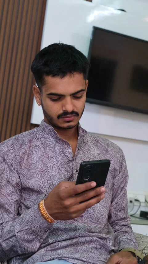 Young Man Missing Someone While Looking at Smartphone Stock Footage 330738448