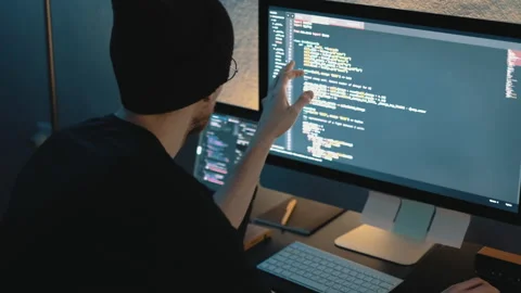 Young man mobile developer writes program code on a computer Stock Footage 145087896