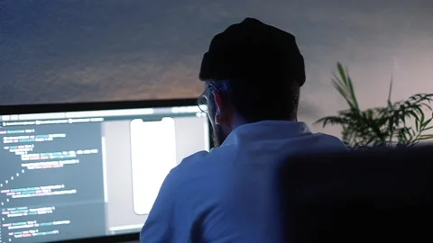 Young man mobile developer writes program code on a computer Stock Footage 166691266