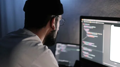 Young man mobile developer writes program code on a computer Stock Footage 166691376