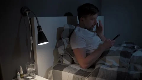 Young man mobile phone addict does not sleep, suffers from insomnia at night in Stock Footage 145487997