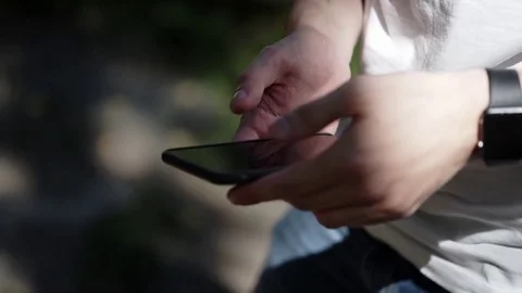 Young man with mobile phone and smart watch Stock Footage