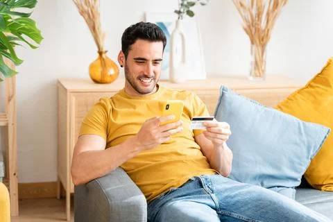 Young man with mobile phone checking his bank statement. Foto stock